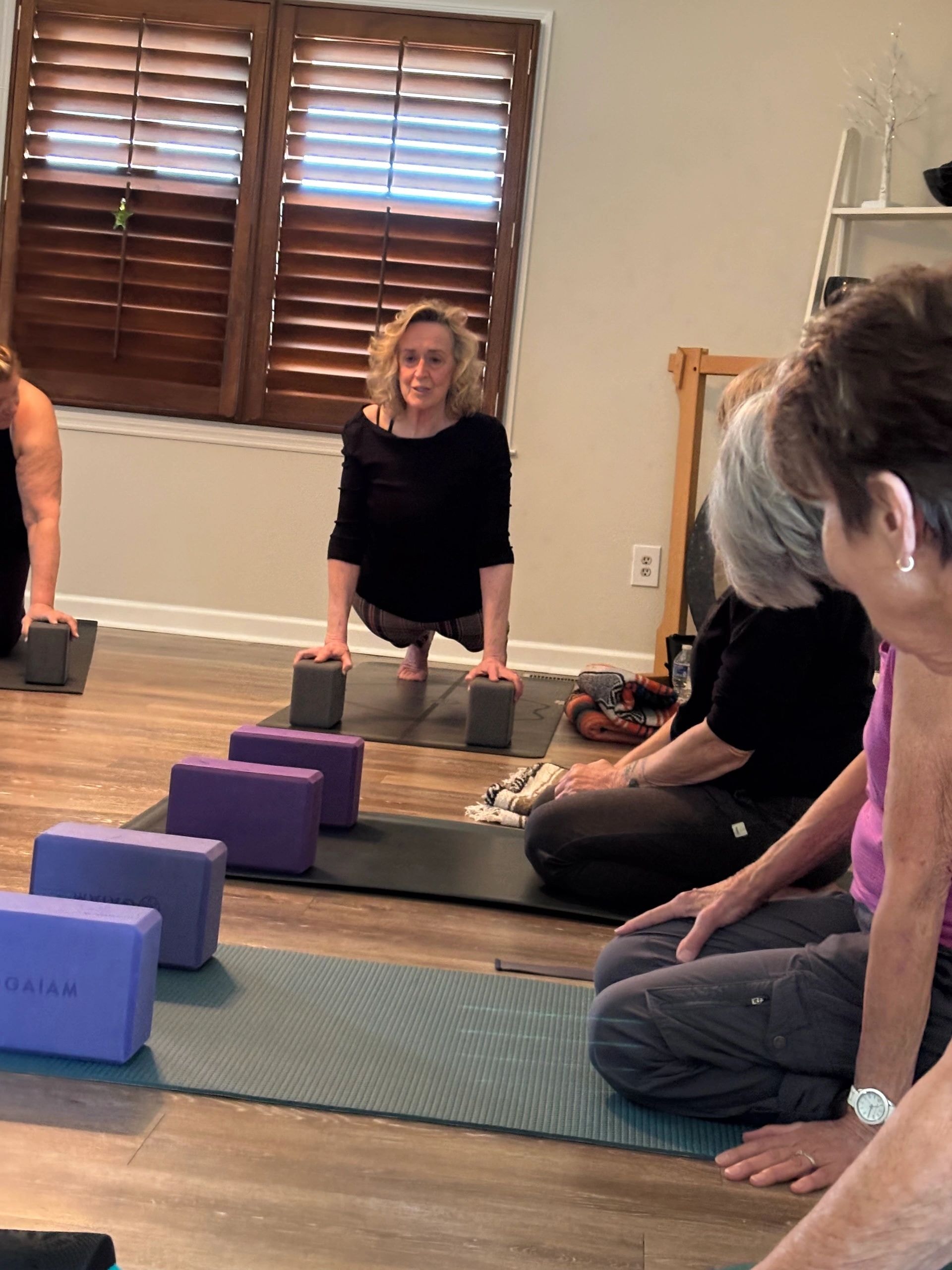 Claire teaching a small yoga class in her home studio